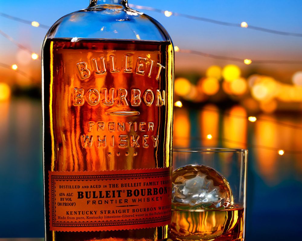 Bulleit Bourbon by the water photo by Jens Johnson Photography. Premium food, beverage, and product photography for Connecticut and New York.