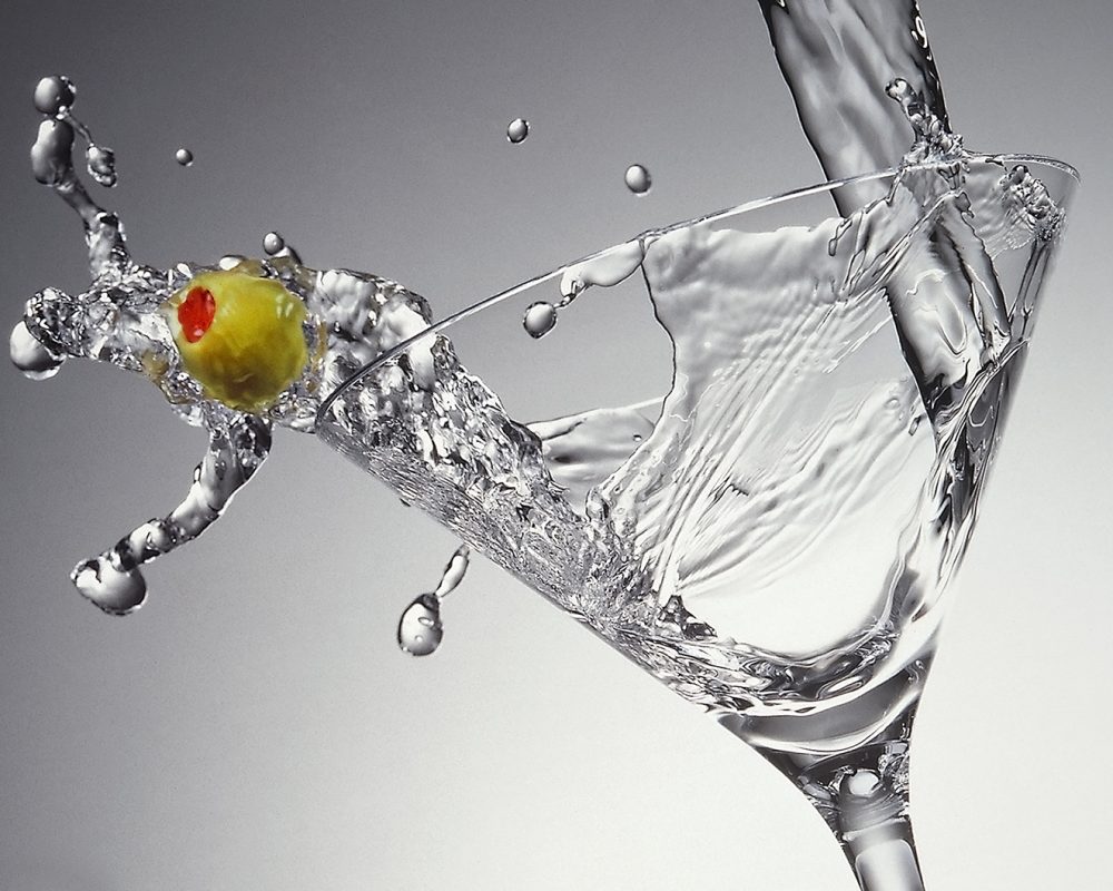 Martini with an olive splash photo by Jens Johnson Photography. Premium food, beverage, and product photography for Connecticut and New York.